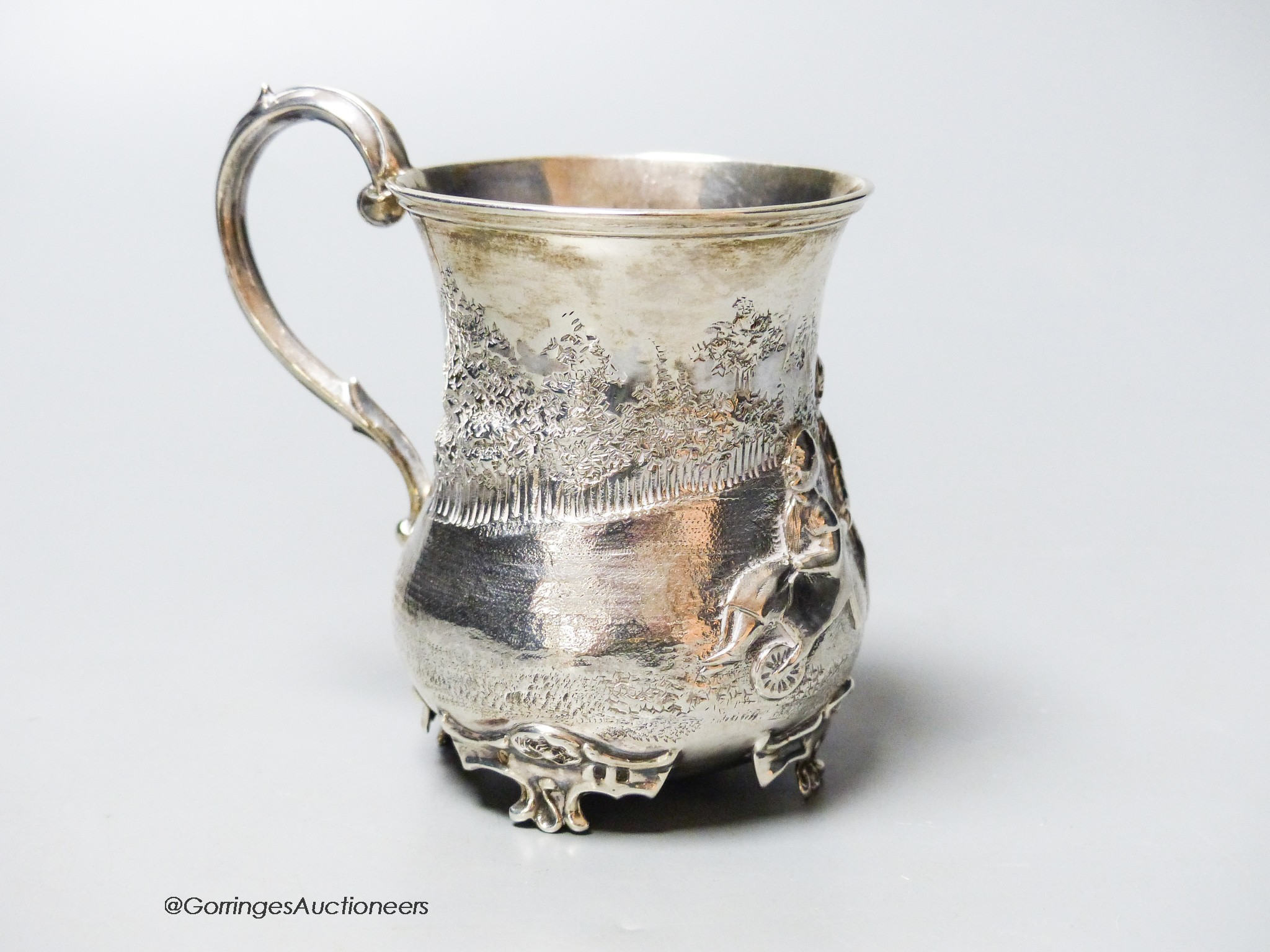 A Victorian silver christening mug, embossed with children and a wheelbarrow, George John Richards, London, 1855, 87mm, 83 grams.